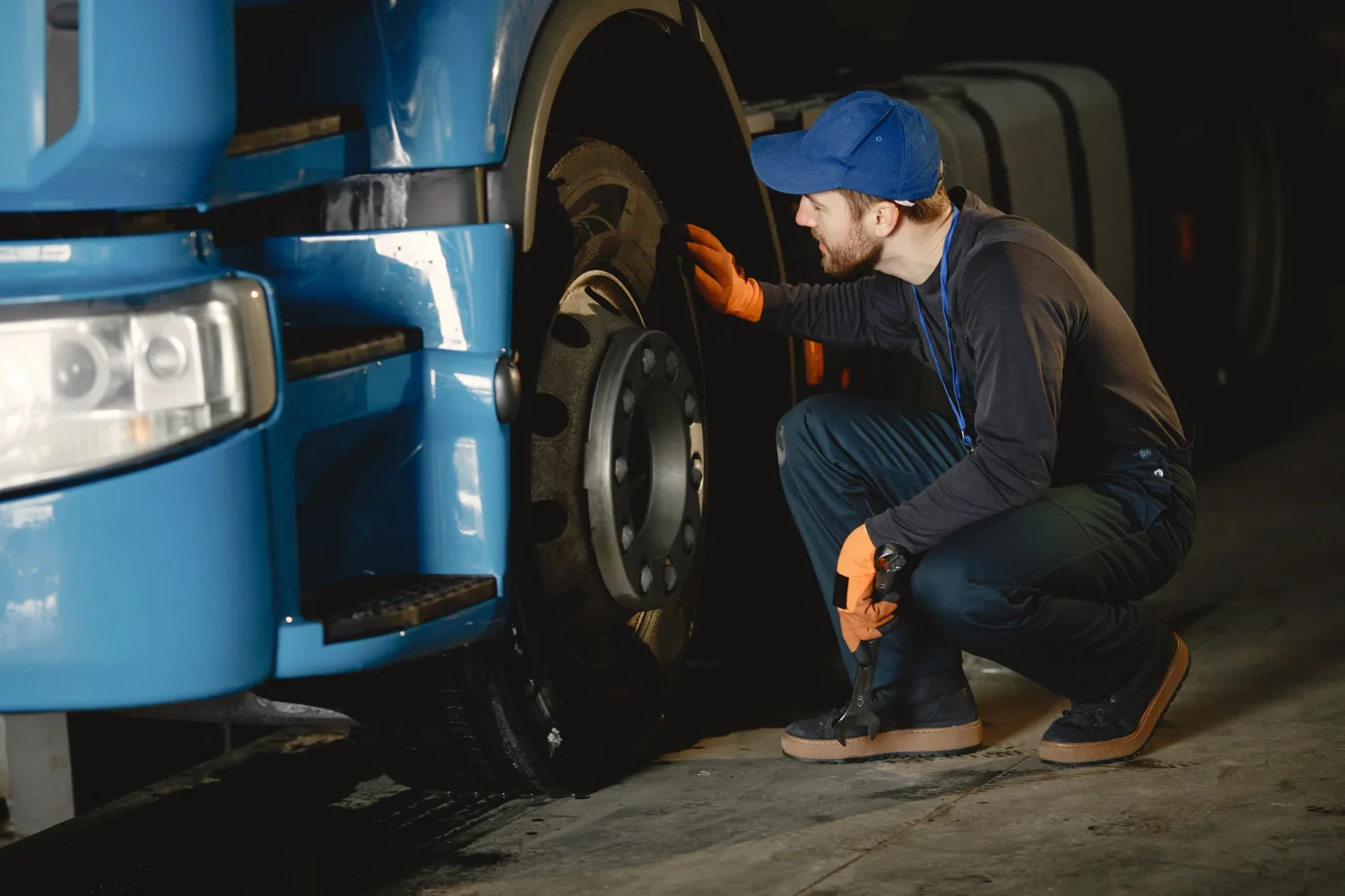 Technician inspecting truck wheel for tire malfunction — Alpha Brothers heavy duty tire change Sacramento