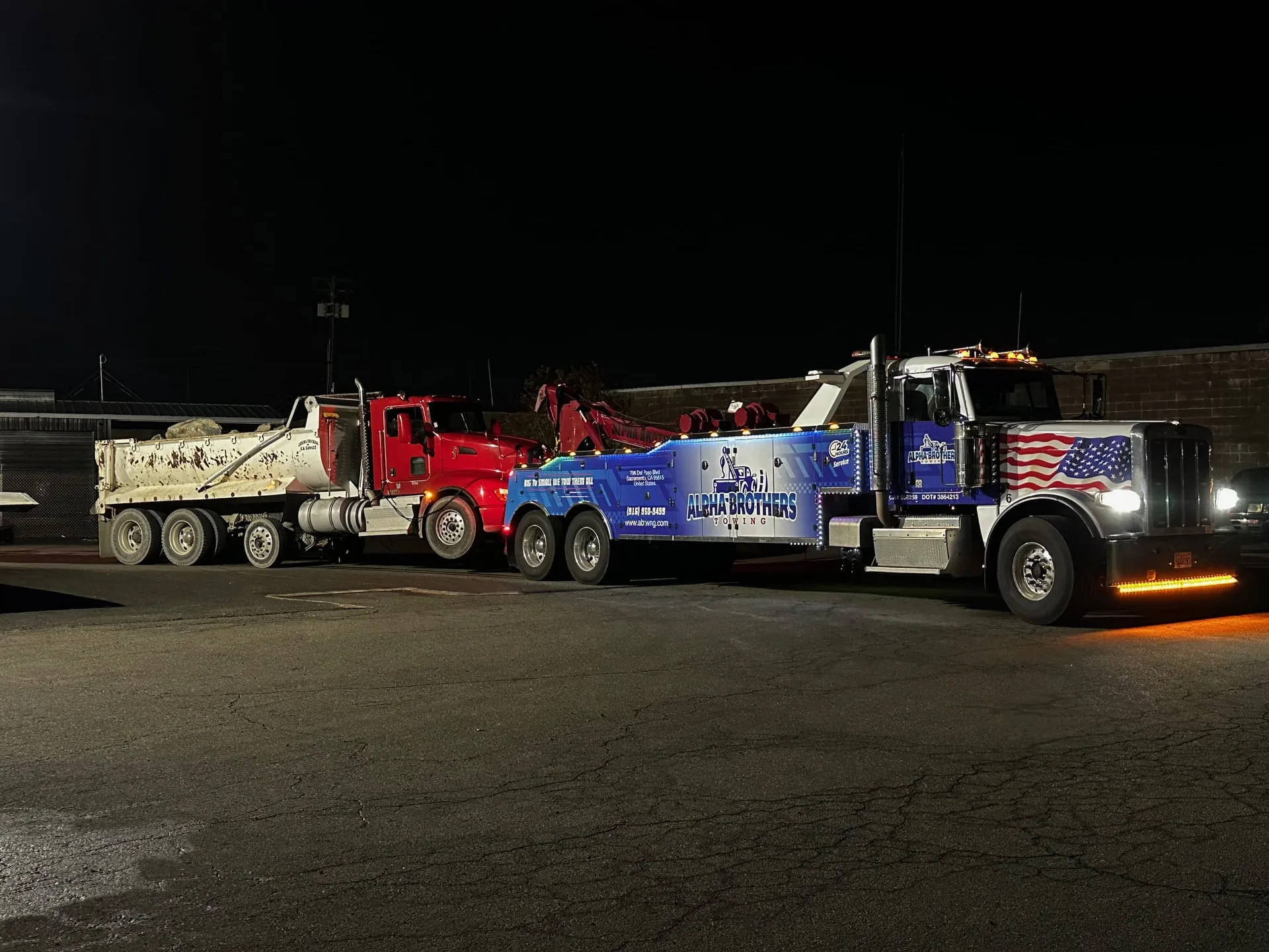 Alpha Brothers Towing Peterbilt heavy wrecker with American flag graphics towing a VSP Vision motorhome in Sacramento, CA